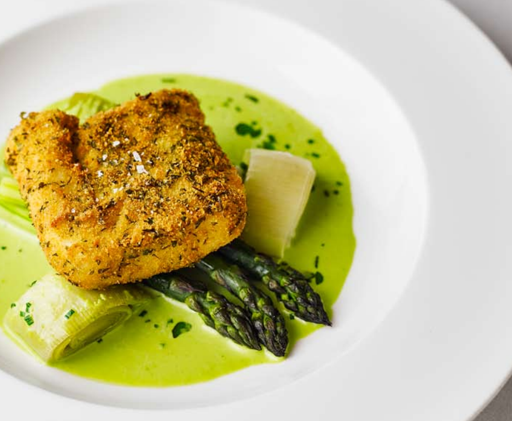 Breaded hake, asparagus and wild garlic sauce